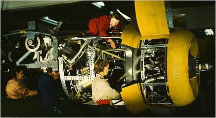 Installing one of the 4 motors on the transport plane at Willow Run (LOC)